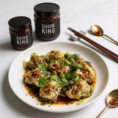 Shiok King Chilli Oil served over dumplings with chopsticks